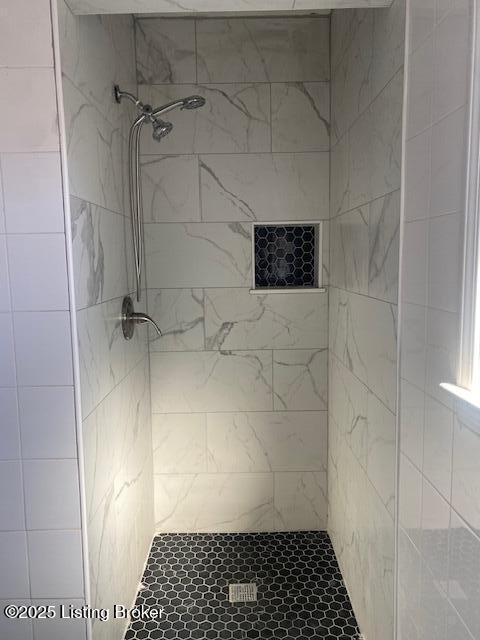 bathroom with a tile shower