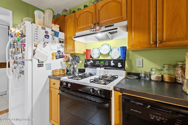 kitchen featuring light tile patterned flooring, range with gas stovetop, dishwasher, white fridge, and a textured ceiling