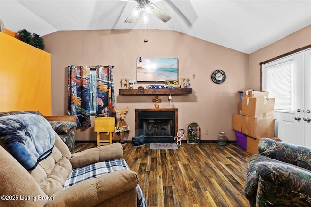 living room with hardwood / wood-style flooring, vaulted ceiling, and ceiling fan