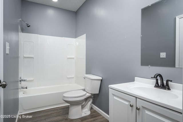 full bathroom with vanity, hardwood / wood-style floors, shower / bathtub combination, and toilet