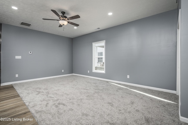 empty room with hardwood / wood-style floors, a textured ceiling, and ceiling fan