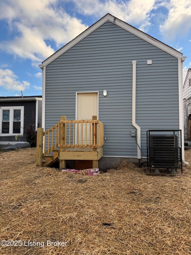 rear view of house with central air condition unit