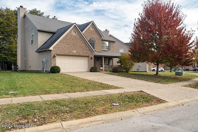 view of front of house with a front lawn and a garage