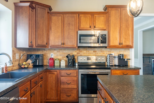 kitchen featuring an inviting chandelier, stainless steel appliances, decorative backsplash, crown molding, and sink