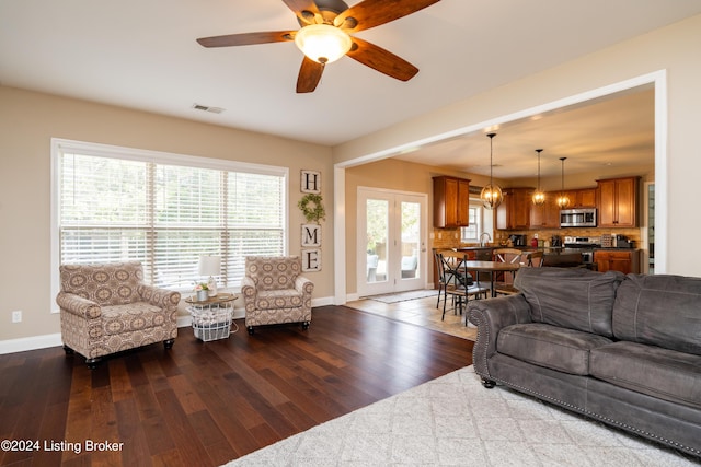 living room featuring ceiling fan, wood-type flooring, and sink