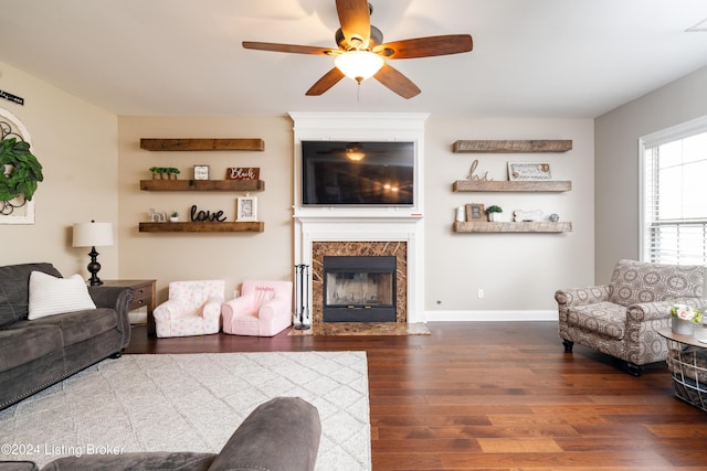 living room with ceiling fan, dark hardwood / wood-style floors, and a fireplace