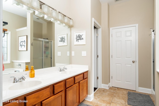 bathroom featuring walk in shower, vanity, and tile patterned flooring