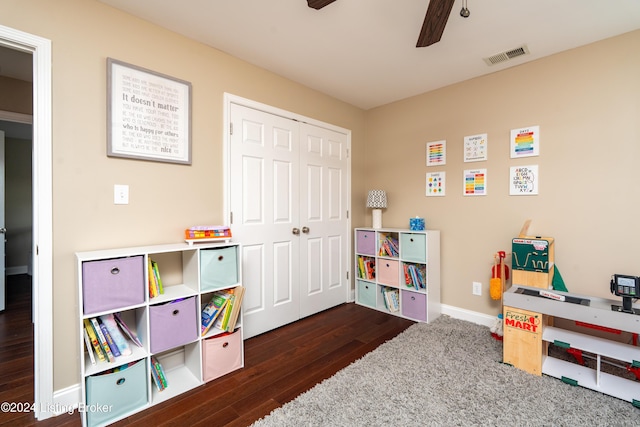 rec room with ceiling fan and dark wood-type flooring