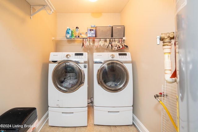 laundry room featuring washing machine and dryer and water heater