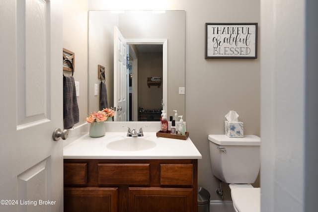 bathroom featuring toilet and vanity