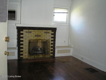 details with hardwood / wood-style flooring and a fireplace