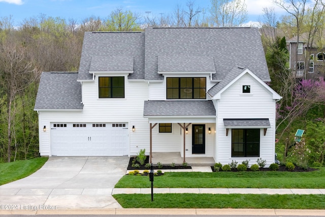 view of front of home featuring a front lawn and a garage