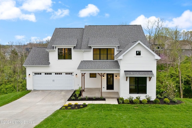 modern farmhouse style home featuring a garage, covered porch, and a front yard