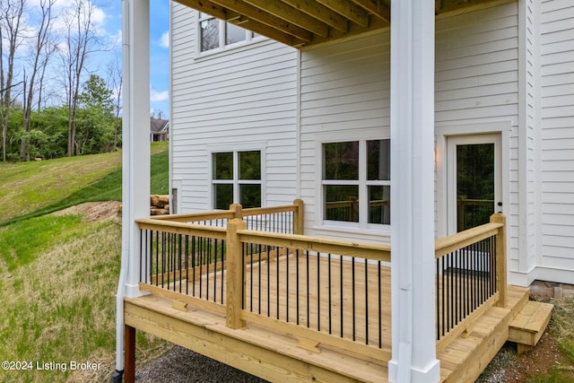 wooden terrace featuring a lawn