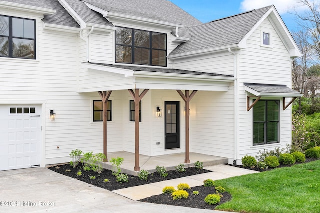 view of front of property with a porch and a garage