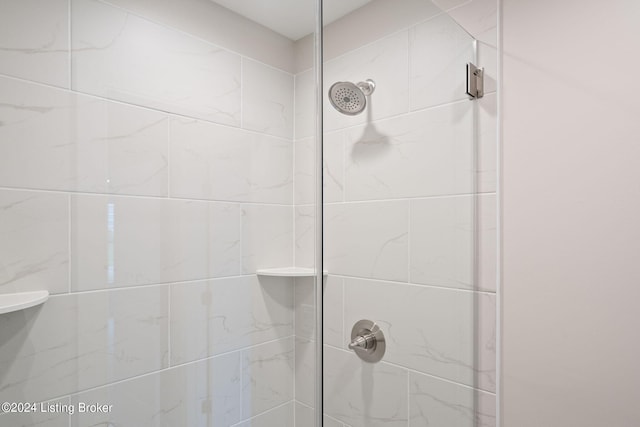 bathroom with tiled shower