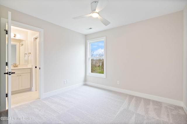 unfurnished room featuring ceiling fan and light colored carpet