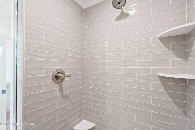 bathroom with a tile shower