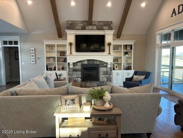 living room featuring hardwood / wood-style flooring, high vaulted ceiling, beam ceiling, and a fireplace