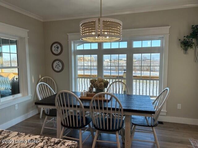 dining space with dark hardwood / wood-style floors and ornamental molding