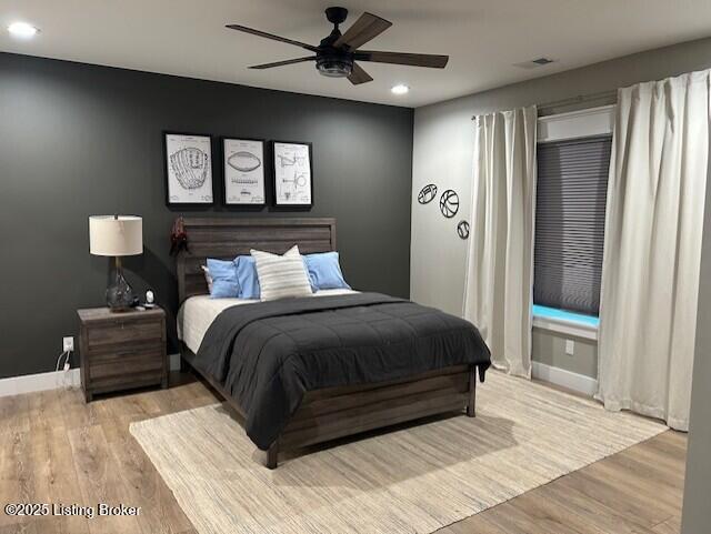 bedroom with ceiling fan and light hardwood / wood-style flooring