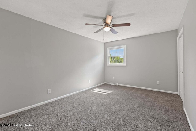 spare room with carpet floors, a textured ceiling, and ceiling fan