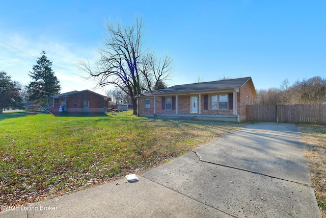 single story home with covered porch and a front yard