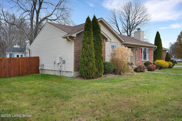 view of side of property featuring a lawn