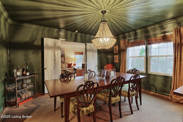 dining area with carpet and a notable chandelier