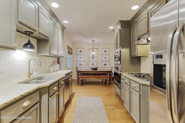 kitchen with appliances with stainless steel finishes, tasteful backsplash, hanging light fixtures, billiards, and sink