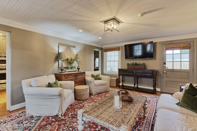 living room with ornamental molding, a chandelier, and hardwood / wood-style flooring