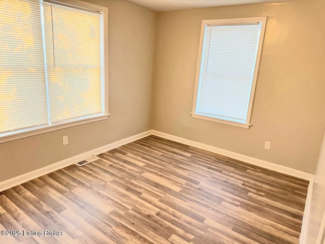 unfurnished room featuring hardwood / wood-style flooring