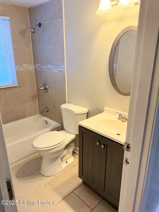 full bathroom with toilet, tiled shower / bath combo, tile patterned floors, and vanity