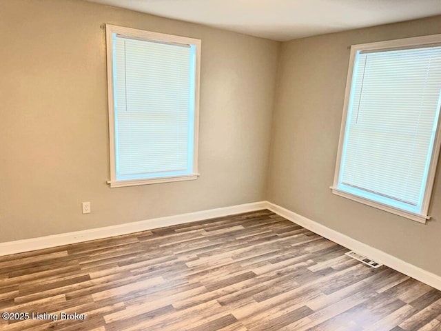 unfurnished room featuring hardwood / wood-style floors