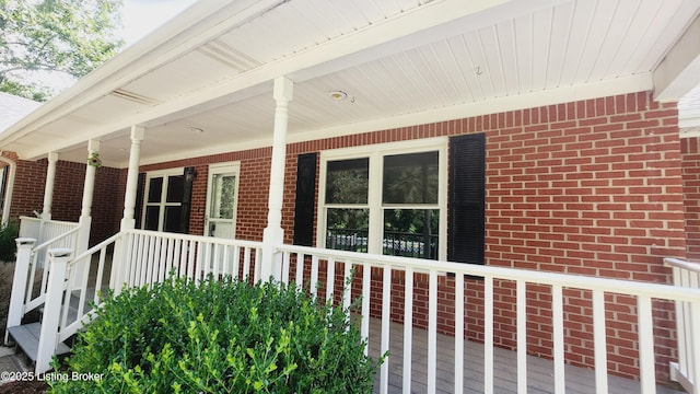 view of side of property featuring covered porch