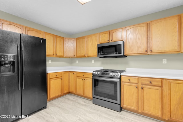 kitchen with stainless steel appliances and light brown cabinets