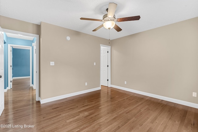 spare room featuring ceiling fan and hardwood / wood-style flooring