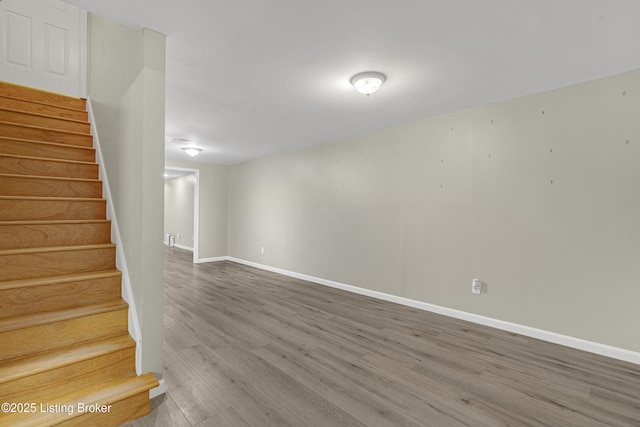 basement with hardwood / wood-style flooring