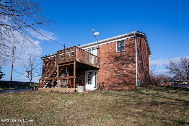 rear view of property featuring a deck and a yard