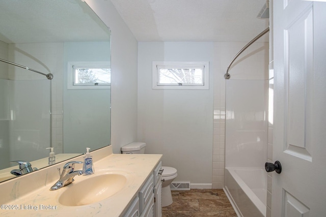 full bathroom featuring toilet, vanity, and bathing tub / shower combination