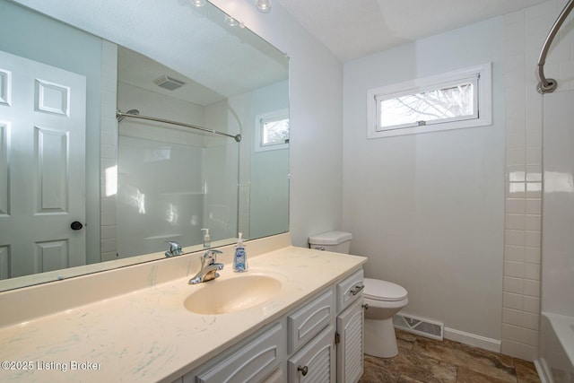 full bathroom with toilet, vanity, and tiled shower / bath combo