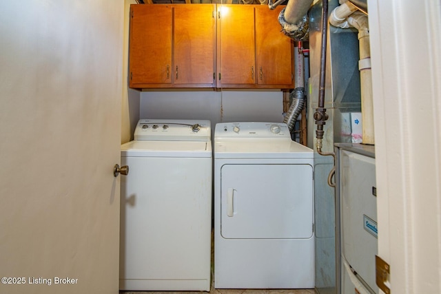 laundry room with washer and clothes dryer and cabinets