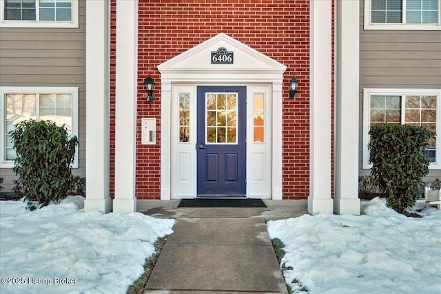 view of snow covered property entrance