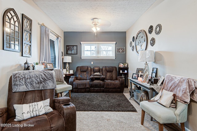 living room featuring ceiling fan, a textured ceiling, and carpet flooring