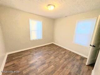 unfurnished room featuring dark hardwood / wood-style floors