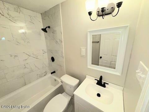 full bathroom featuring toilet, tiled shower / bath combo, and vanity