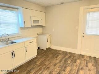 kitchen featuring sink, white cabinets, and dark hardwood / wood-style floors