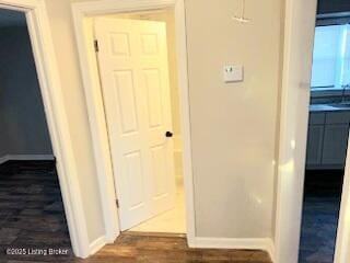 hallway with dark hardwood / wood-style flooring