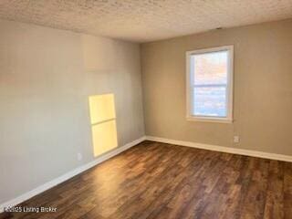 unfurnished room with dark hardwood / wood-style floors