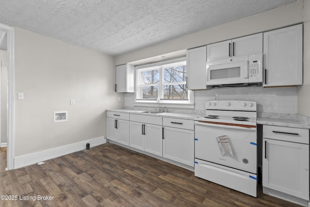 kitchen with a sink, tasteful backsplash, dark wood finished floors, white appliances, and light countertops